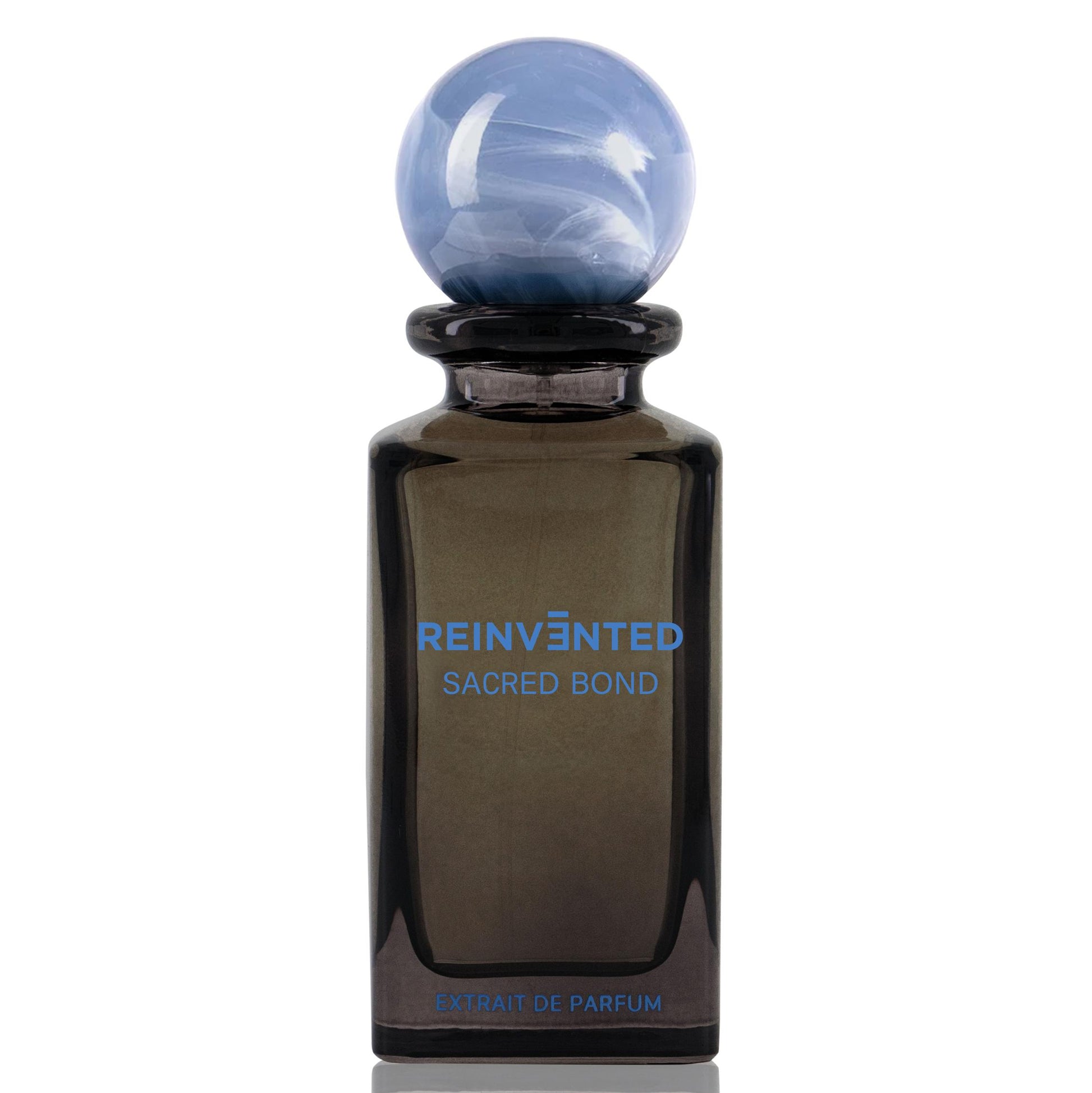 Perfume bottle labeled 'Reinvented Sacred Bond' on a white background