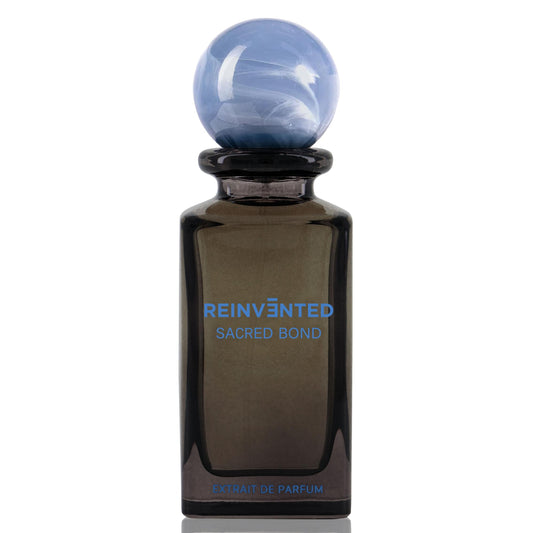 Perfume bottle labeled 'Reinvented Sacred Bond' on a white background